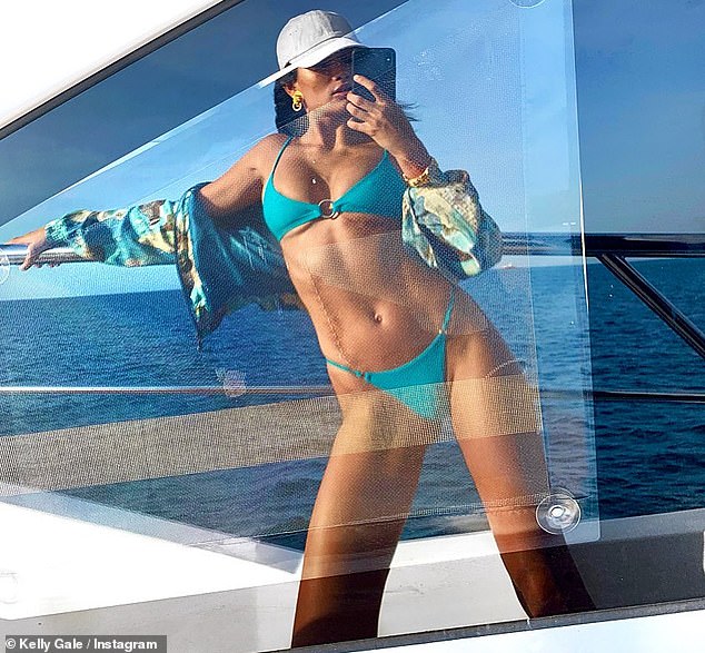 Model Kelly Shows Off Her Ample Cleavage And Tummy In A Sexy Blue Bikini
