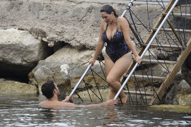 Kelly Brook puts on an eye-popping display as her swimsuit struggles to contain her cleavage